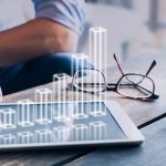 Businessman analyzing growing 3D AR chart above tablet computer screen